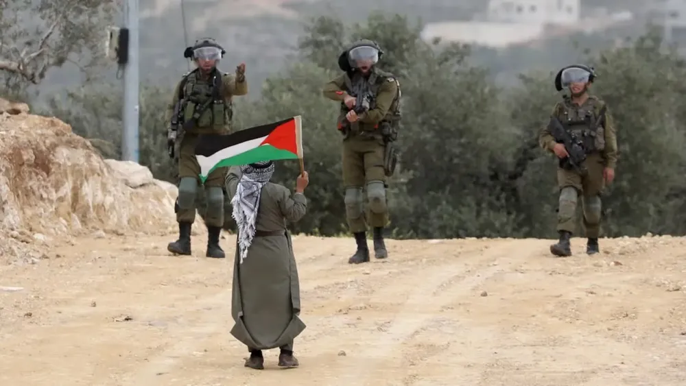 un-hombre-lleva-una-bandera-palestina-frente-a-tres-soldados-israelies-cerca-de-nablus-en-cisjordania-foto-efe-FSZKBCWYSNFOBFAQMSL2QBHHHI
