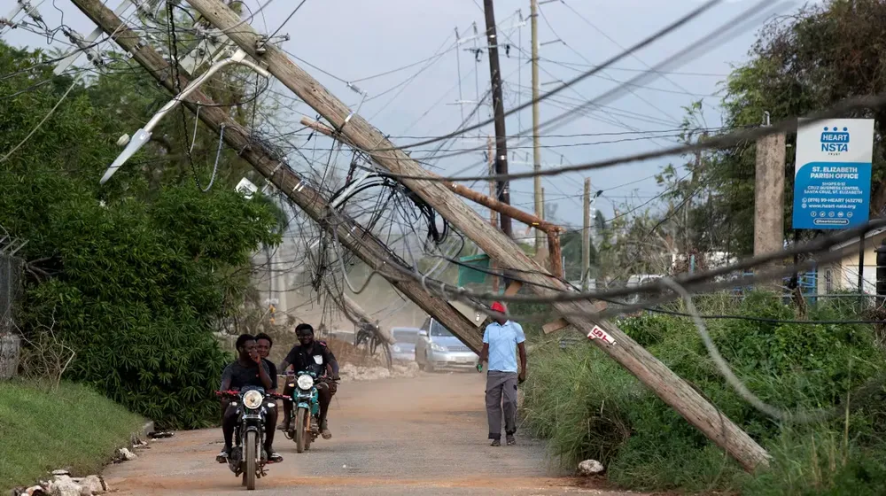 personas-recorren-una-calle-afectada-por-el-paso-del-huracan-melissa-este-jueves-en-santa-cruz-jamai